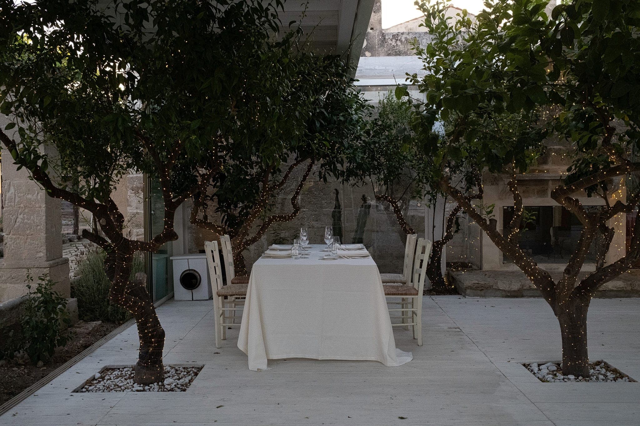 The courtyard at dusk, laid for the welcome dinner